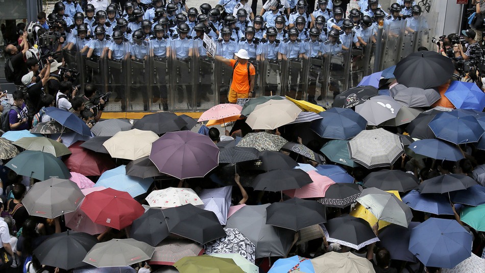 Standoff between Hong Kong police and protesters with their shields